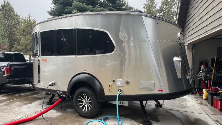 An Airstream Basecamp travel trailer, an rv rental, prepped for adventure. Connected to water/power, ready for outdoor camping.. Airstream Basecamp 2022