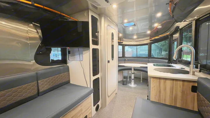 Experience comfort in this RV rental: modern interior with kitchen, dinette, and TV.. Airstream Basecamp 2022