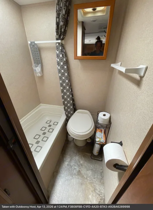 Compact RV rental bathroom featuring a toilet, small tub/shower, mirror, and essential amenities for travelers.. Jayco Jay Flight SLX 2016