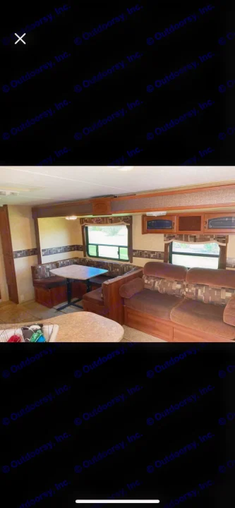 RV rental interior: comfy sofa, U-shaped dinette, and overhead storage cabinets. Ideal for travel.. Forest River Tracer Executive 2010