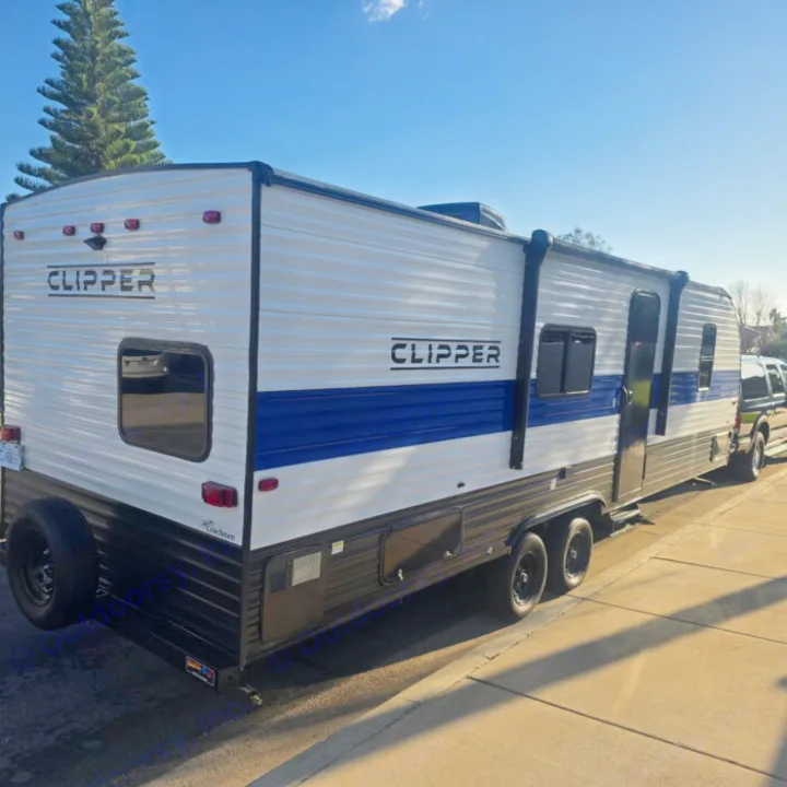 This sleek white and blue Clipper travel trailer is perfect for your next rv rental adventure, offering comfort for camping.. Clipper 5K 2024
