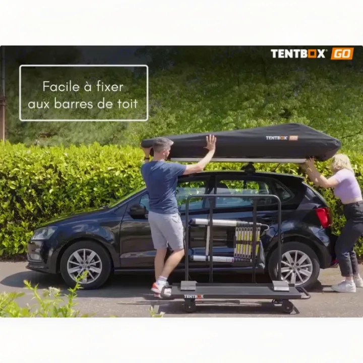 Two people lift a TENTBOX GO roof tent onto a car's roof rack for adventure camping or RV rental travel.. TENTBOX GO 2026