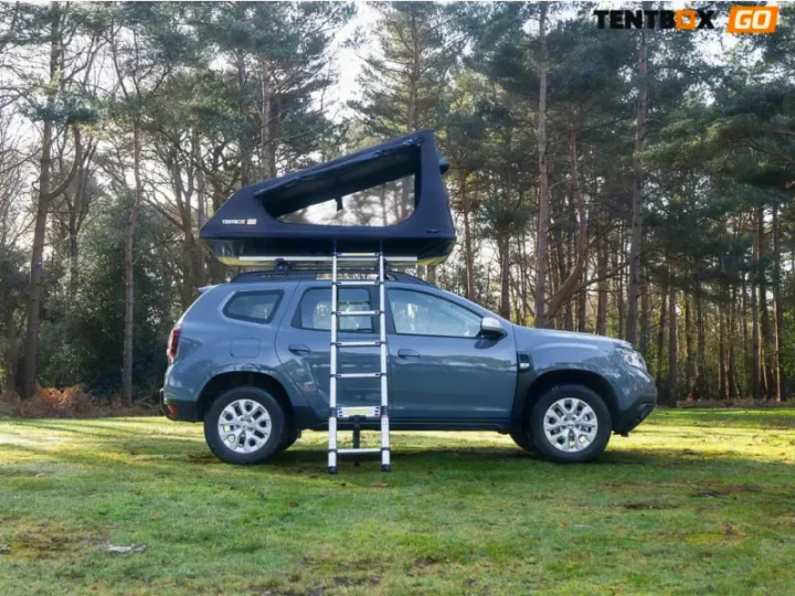 Ready for adventure? This grey SUV with a TentBox GO roof-top tent setup offers a unique rv rental experience in the forest.. TENTBOX GO 2026