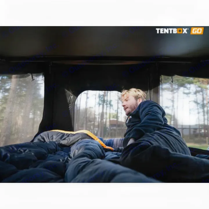 Relax inside a TentBox GO rooftop tent. Perfect for your RV rental adventure, combining camping comfort with nature views.. TENTBOX GO 2026