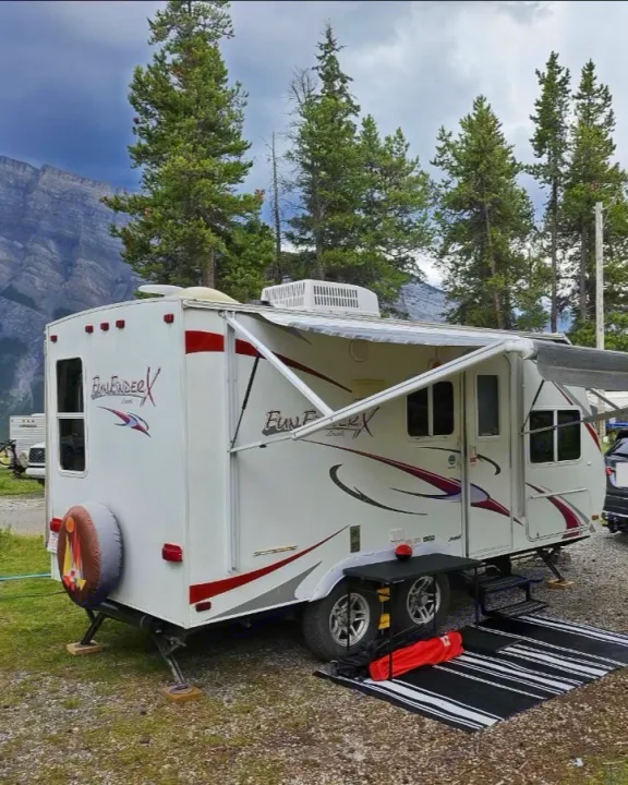 Enjoying nature with this Fun Finder RV rental & SUV at a scenic mountain campsite among pine trees.. Cruiser RV Fun Finder X 2011