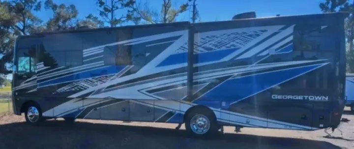 Experience freedom in this dark Georgetown motorhome, featuring bold blue & white graphics, perfect for your rv rental.. Forest River GEORGETOWN 36D7 2024