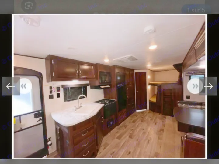 Spacious RV rental interior: kitchen with dark cabinets, sink, stove; dining area, and bunk beds.. Jayco Jay Flight SLX 2018