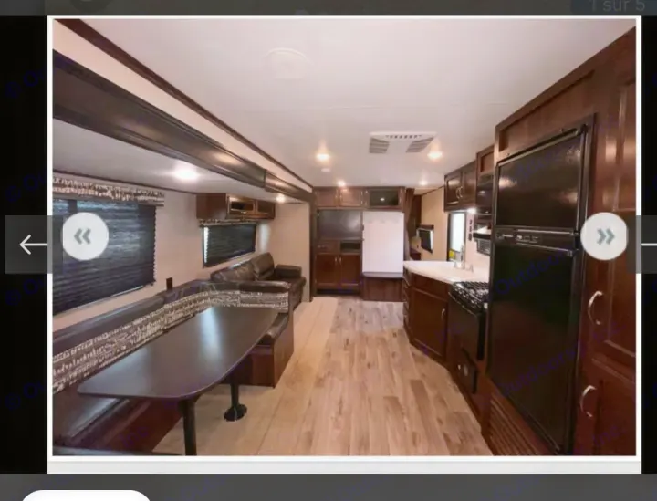 RV rental: Spacious interior with U-shaped dining booth, full kitchen (fridge, stove), and rich dark wood finishes. Light wood-look floor.. Jayco Jay Flight SLX 2018