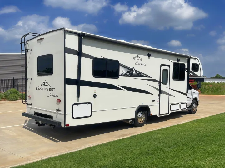 East & West Entrada Class C RV rental, white with mountain decals, parked on concrete. Ready for your next adventure!. Entrada Entrada Motorhome 2022