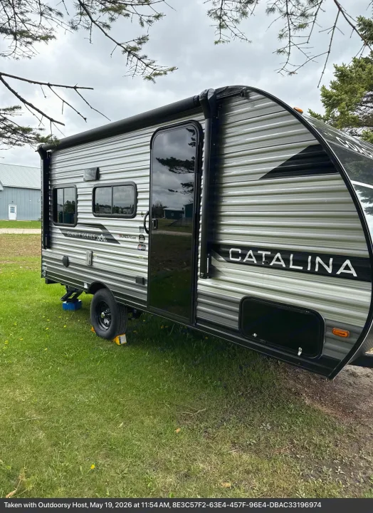 Explore with this stylish Catalina Summit Series rv rental, a modern travel trailer parked on a grassy site.. Coachmen Catalina 2025