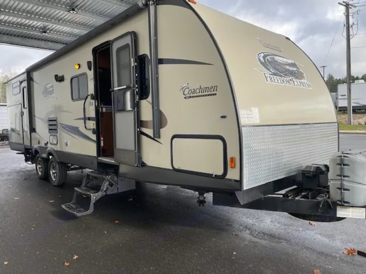 Spacious Coachmen Freedom Express RV rental travel trailer with an open door and awning, ready for your next adventure.. Coachmen Freedom Express 2015