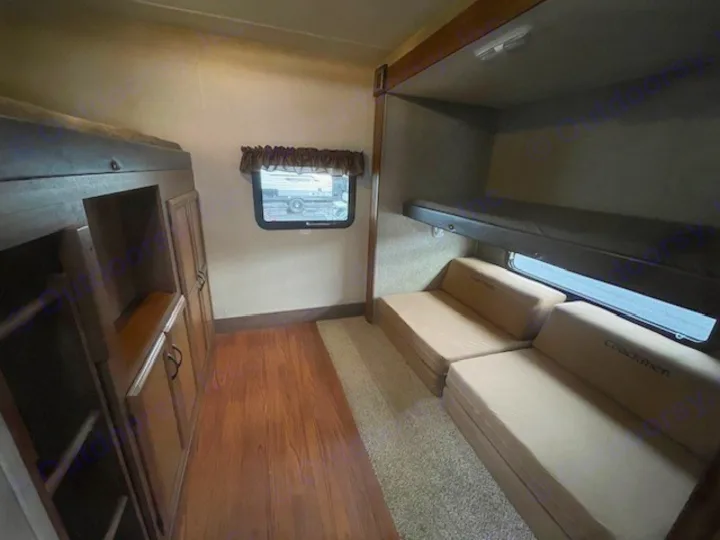 Spacious RV rental bunkhouse featuring multiple bunk beds, fold-out seats, and storage for a comfortable family trip.. Coachmen Freedom Express 2015