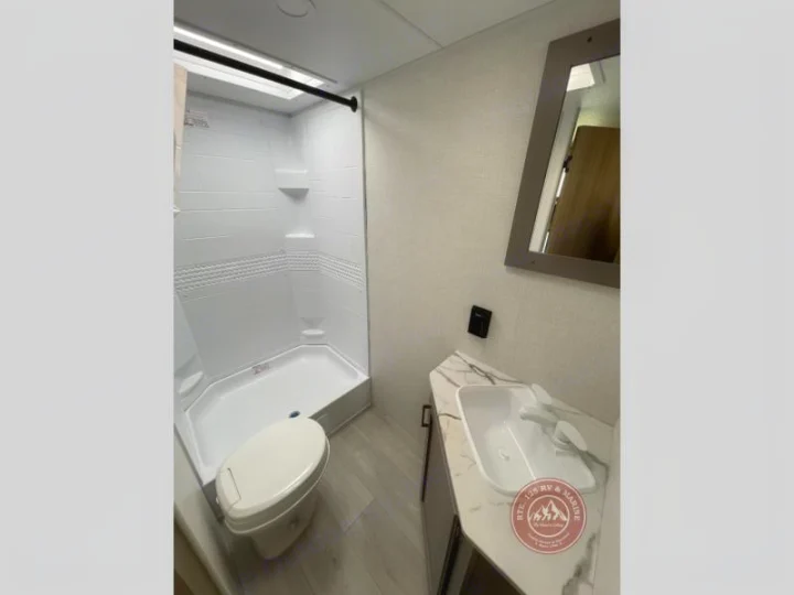 Get ready for your next trip! This RV rental features a compact bathroom with a modern shower, toilet, and sink vanity.. KZ Sportsmen Select 2026