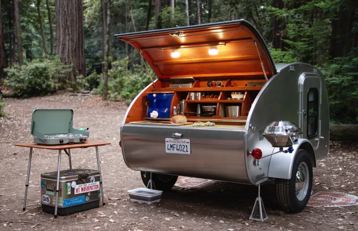 Camping rv rental: A sleek teardrop trailer with an open rear kitchen, ready for outdoor meals in a serene redwood forest.. All Good Equipment Company Teardrop Trailer 2026
