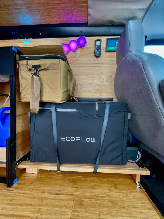 RV rental interior with an Ecoflow portable power station & cooler on custom storage, ready for van life adventures.. Ford E350 2010