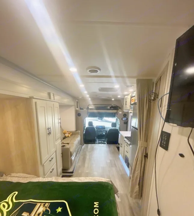 Spacious RV rental interior featuring a bed, kitchen, sofa, and cockpit view. This modern, well-lit mobile home awaits your adventure.. Isata 3 Series 2026