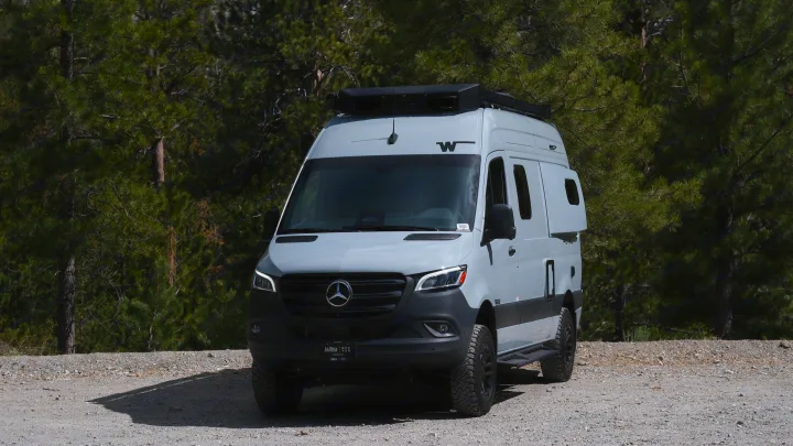 Adventure-ready Mercedes-Benz Sprinter RV rental on a gravel forest road, ideal for outdoor travel.. Other Other 2026