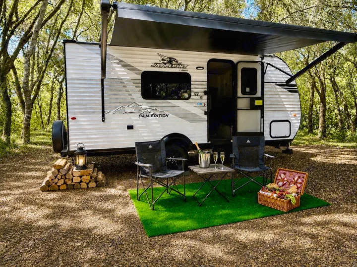 Jay Flight RV rental in a serene wooded campsite, ready for your outdoor adventure with a cozy setup.. Jayco Jay Flight SLX 175 FQW Baja 2026