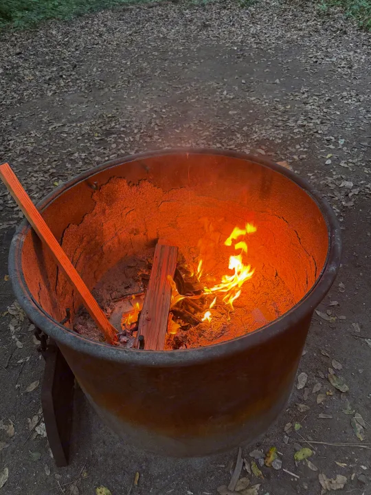 A warm campfire glows in a metal fire pit, perfect for evening ambiance during your RV rental adventure.. Jayco Jay Flight SLX 175 FQW Baja 2026