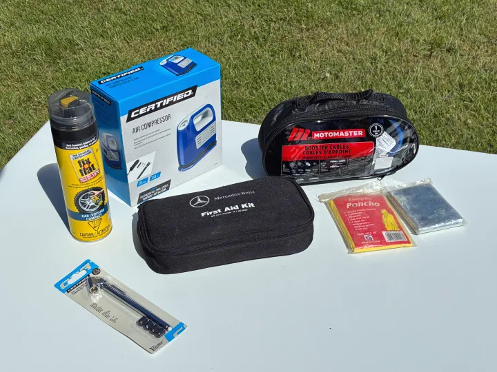 RV rental safety kit: air compressor, tire sealant, booster cables, first aid, poncho, thermal blanket, and tire gauge.. Dodge Grand Caravan 2005