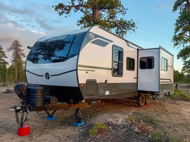This RV rental is perfectly set up for camping in nature, featuring an extended slide-out and leveling blocks.. Forest River Unmapped 2026