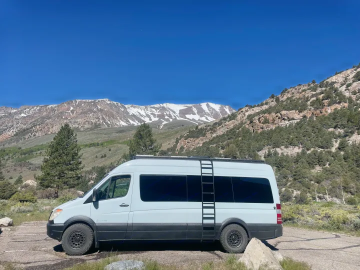 Your next adventure starts here! An Activan RV rental rests amidst majestic snow-capped mountains and a clear blue sky.. Mercedes-Benz Sprinter RV Motorhome Campervan 2012