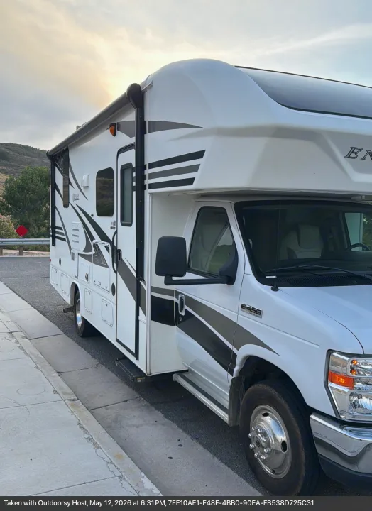 White and grey E450 Super Duty RV rental motorhome parked roadside at sunset. Your next adventure awaits!. Entegra Coach Odyssey 2019