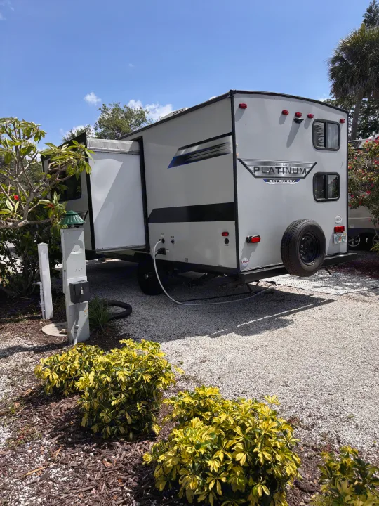 Sunny Florida RV rental set up at a campsite with utilities connected, slide-out extended for your adventure.. Forest River Salem FSX PLATINUM 2020