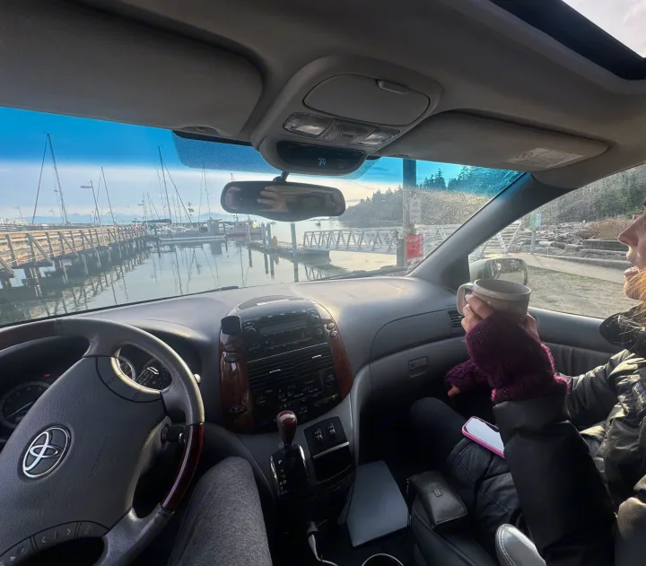 From our vehicle, enjoying a marina view with sailboats, coffee in hand. Planning our RV rental adventure, outside temp 34. Scenic travel.. Toyota Sienna Limited XLE Camper Van 2004