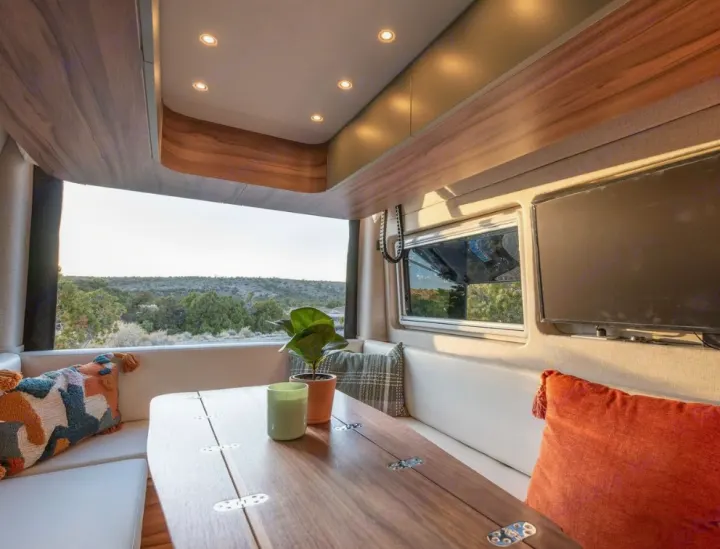 Cozy RV rental interior with dinette, scenic view, and modern amenities for your next adventure.. Noovo Plus LB 2025