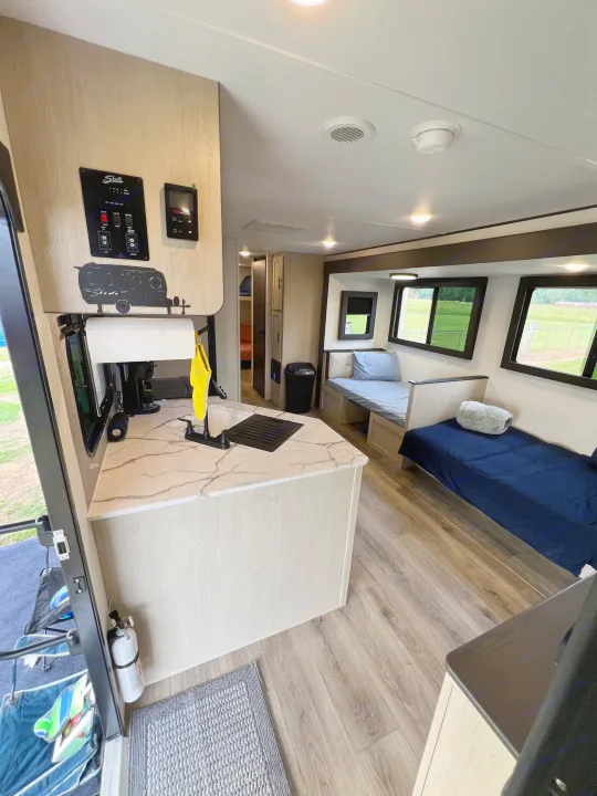 rv rental: Interior view of kitchen counter, sink, control panel, dinette beds, and wood flooring.. Forest River Shasta I-5 2026