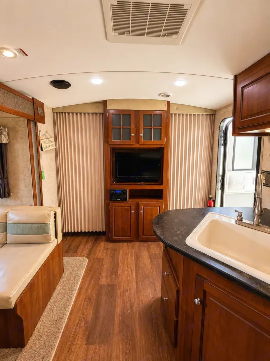 This RV rental offers a well-appointed interior with a kitchen sink, entertainment center, and cozy dinette.. Keystone RV Bullet Ultra Lite 2013