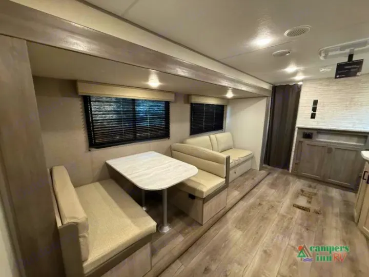 Enjoy this bright RV rental living space! Features a comfortable dinette, sofa seating, and large windows. Perfect for your next trip.. Coachmen Catalina 2025