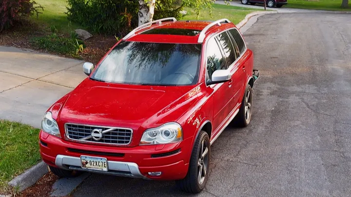 Red Volvo XC90 SUV, a spacious ride. Explore travel options; consider an RV rental or this versatile SUV.. Volvo xc90 2014