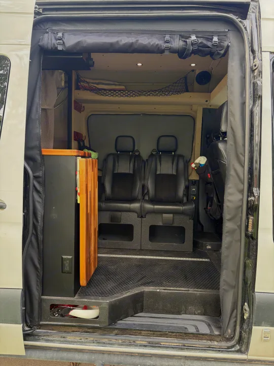 Inside an rv rental camper van: comfortable seating, compact kitchenette, and smart storage solutions for mobile adventures.. Mercedes Sprinter 2019