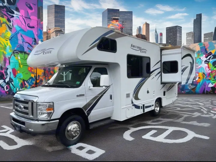 Freedom Elite RV rental in a vibrant city scene with graffiti art and skyscrapers, ready for your next adventure.. THOR MOTOR COACH Freedom Elite 2019
