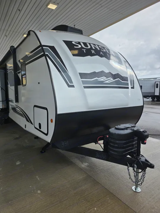 Experience the open road with this white and black Sunset Trail travel trailer, a perfect choice for your next RV rental adventure.. Crossroads RV Sunset Trail Super Lite 2025