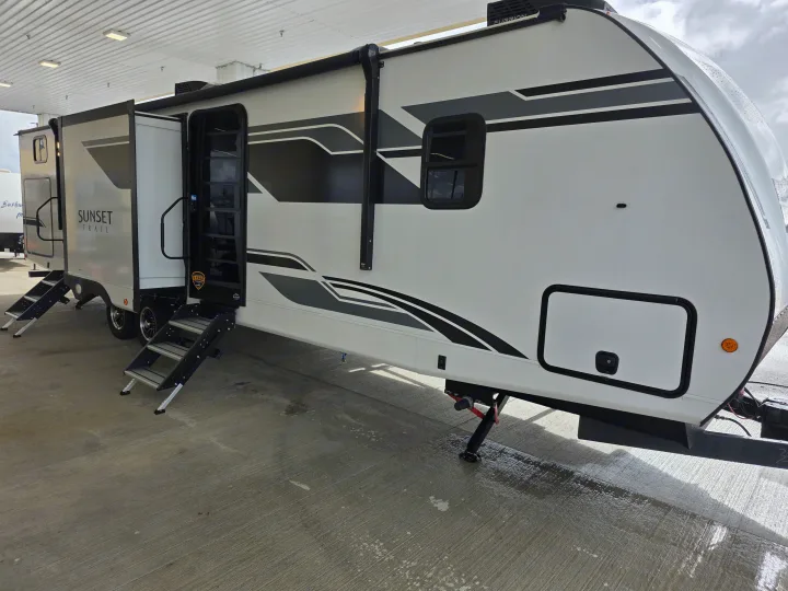 This white Sunset Trail RV rental travel trailer is parked with its entry door open and steps extended, ready for a trip.. Crossroads RV Sunset Trail Super Lite 2025