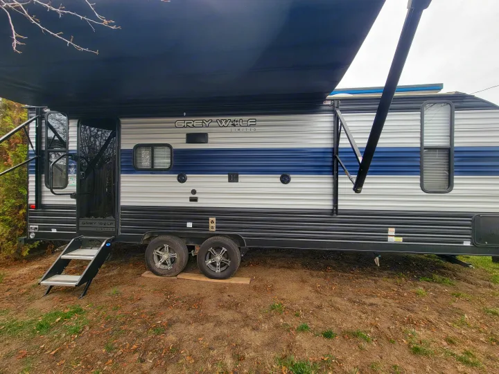 Grey Wolf travel trailer RV rental, with awning out & steps down, parked for camping.. Forest River Cherokee Grey Wolf 2022