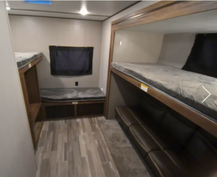 RV rental: Cozy bunk beds, a comfortable sofa, and a versatile bench with storage inside this modern interior.. Crossroads RV Zinger 2021