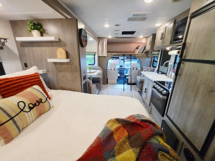 Spacious & cozy RV rental interior, featuring a comfortable bed, modern kitchen, and dinette, perfect for your next adventure.. Forest River Coachmen Prism 2018