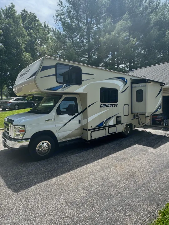 RV rental: A white Conquest Class C motorhome with a slide-out extended, parked on a paved driveway.. Gulf Stream Conquest 2019