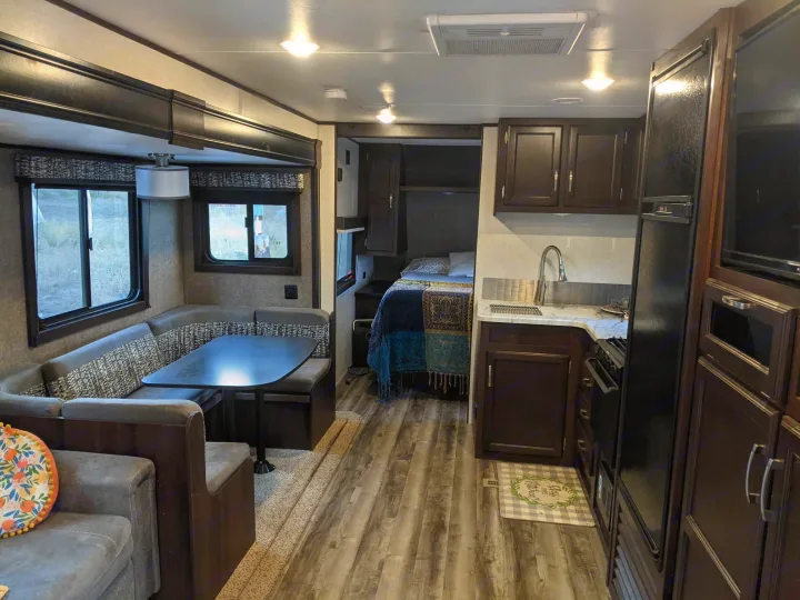 Inside a modern **rv rental**: a spacious dinette, full kitchen area, and cozy bedroom, all ready for your travel.. Jayco Jay Flight 2020