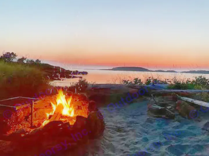 Sunset beach campfire, sparks rising, by calm water. An ideal scene for your next RV rental escape.. Jayco Qwest 2004