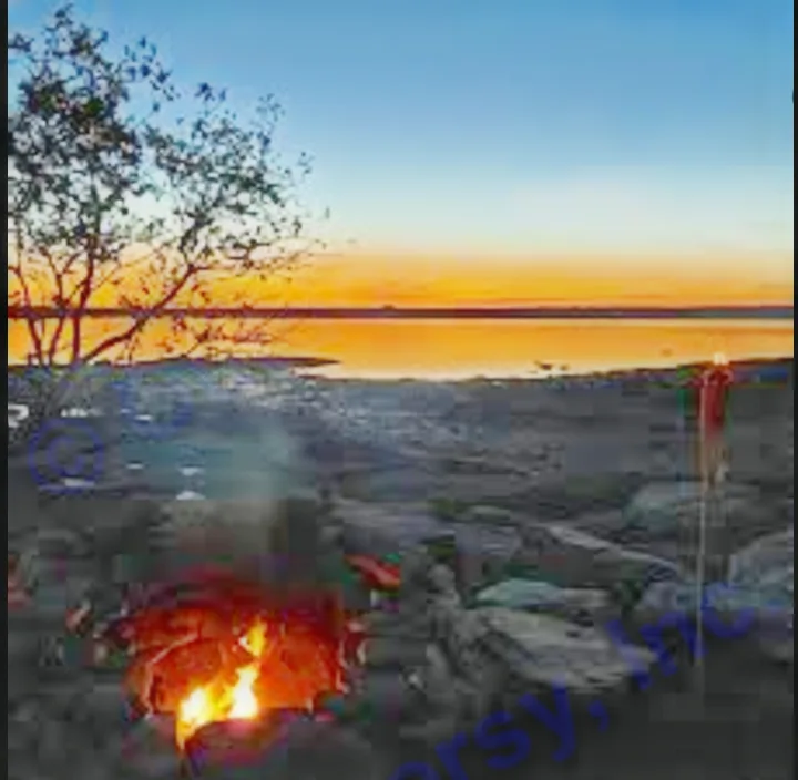 Campfire by a serene lake at sunset, perfect for an RV rental adventure. Enjoy outdoor relaxation & travel.. Jayco Qwest 2004