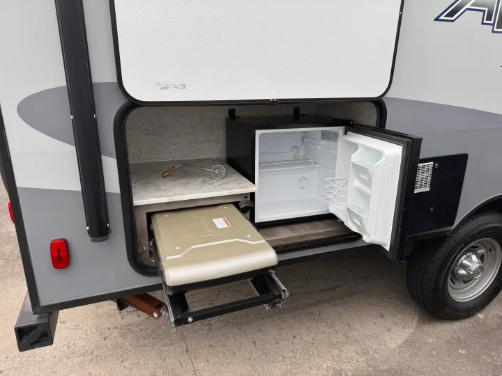RV rental: Compact outdoor kitchen with mini-fridge, countertop, and pull-out Coleman grill for convenient outdoor cooking.. Coachmen Apex Nano 2022