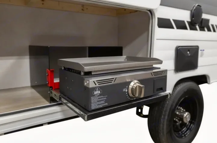 An RV rental provides outdoor cooking with a Capital Griddle on a slide-out tray, extended from its side compartment.. Forest River Salem FSX 2025