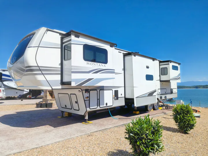 Spacious Montana Legacy fifth-wheel rv rental by the lake, fully set up for a scenic outdoor getaway.. Keystone RV Montana Legacy 3761 FL 2023