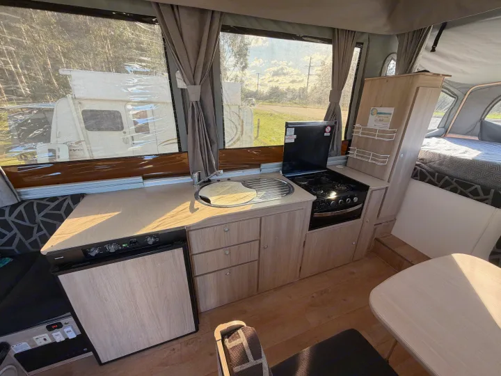Experience mobile living! This RV rental features a full kitchen (sink, stove, fridge), bed, and dining table, all set for camping.. Outback Eagle Off-Road 2015