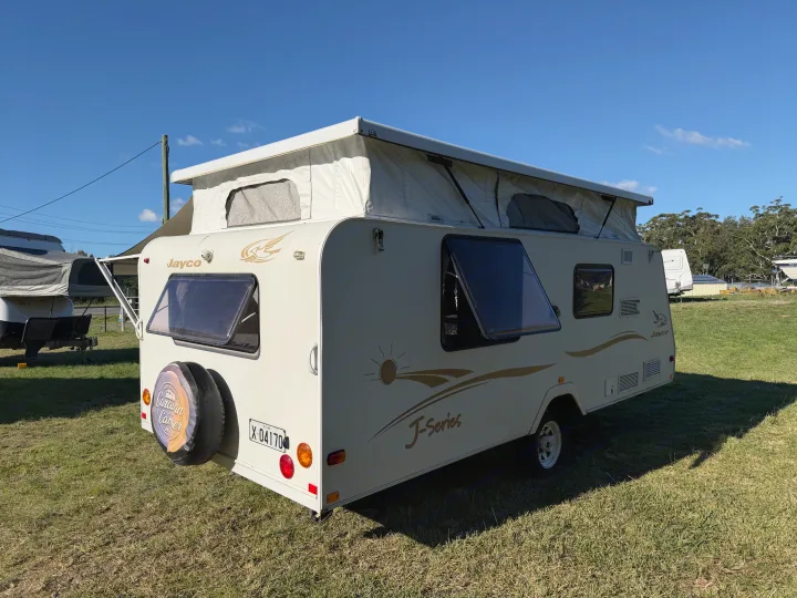 White Jayco J-Series pop-top caravan, an ideal RV rental for outdoor camping trips.. Jayco J Series 2008